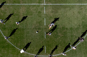 Jogadores do Corinthians fazendo atividade no crculo central do gramado do CT